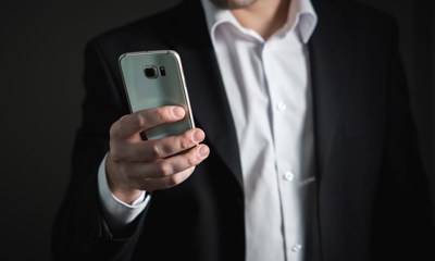 Close Up Of A Business Person Viewing His Mobile Phone